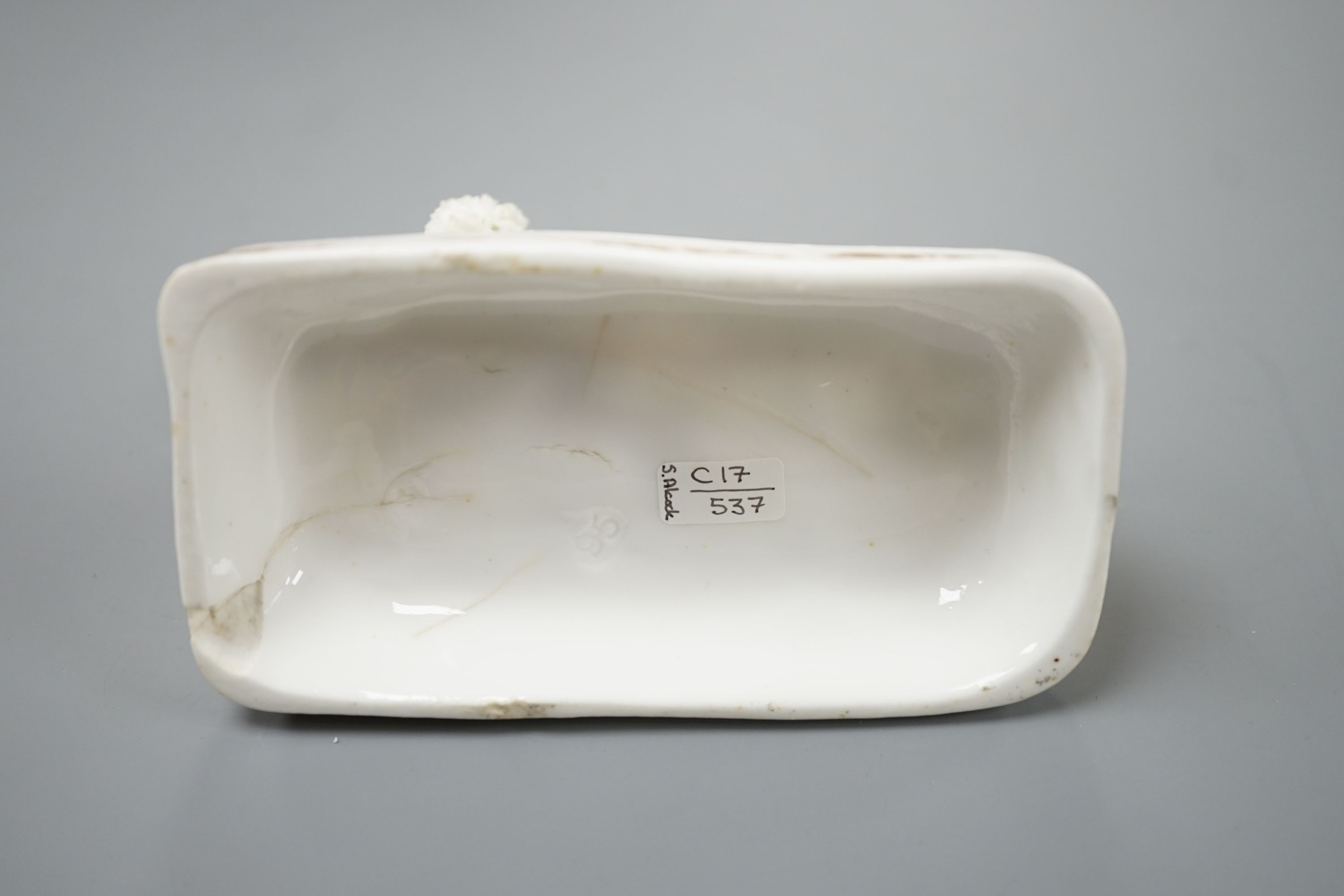 A Samuel Alcock model of a poodle grasping a bone, c.1835–50, 11.1 cm long, Cf. Dennis G.Rice Dogs in English porcelain, colour plate 64., Provenance: Dennis G.Rice collection